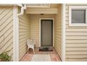 Condo entryway with a screened door and a white metal chair at 3001 Seawind Cir # 10C, Venice, FL 34293