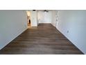 Open living area with light vinyl flooring at 3231 Beneva Rd # 103, Sarasota, FL 34232