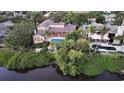 Aerial view showcasing a waterfront property with a pool and private dock at 3310 Sabal Cove Ln, Longboat Key, FL 34228