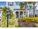 Landscaped front yard with palm trees and walkway to the front door at 3431 Chestertown Loop, Bradenton, FL 34211