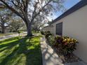 Side view showing the exterior of the villa and landscaping at 3725 Glen Oaks Manor Dr, Sarasota, FL 34232
