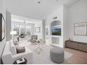 Bright living room featuring a comfortable sofa, stylish chairs, and a large TV at 4152 Central Sarasota Pkwy # 727, Sarasota, FL 34238