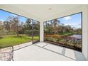 Relaxing screened porch overlooking a tranquil backyard and water feature at 5213 Asher Ct, Sarasota, FL 34232