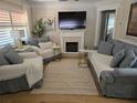 Cozy living room featuring comfortable seating and a modern fireplace at 550 80Th Ave, St Pete Beach, FL 33706