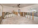 Main bedroom under renovation, showing exposed framing and new flooring at 550 80Th Ave, St Pete Beach, FL 33706