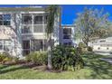 Condo building with lush landscaping and screened balconies at 5697 Sheffield Greene Cir # 51, Sarasota, FL 34235