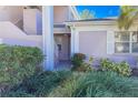 Condo building entry with landscaped grounds at 5697 Sheffield Greene Cir # 51, Sarasota, FL 34235