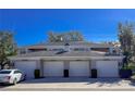 Three-car garage with attached condo units at 5697 Sheffield Greene Cir # 51, Sarasota, FL 34235