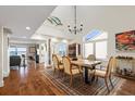 Elegant dining room with hardwood floors, a live-edge table, and water views at 61 Tidy Island Blvd, Bradenton, FL 34210