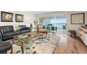 Spacious living room with hardwood floors, comfortable seating, and water views at 61 Tidy Island Blvd, Bradenton, FL 34210