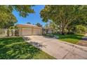 House exterior showcasing a two-car garage, and a well-manicured lawn at 7331 Westmoreland Dr, Sarasota, FL 34243