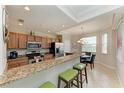 Modern kitchen with granite countertops and breakfast bar at 8105 Grand Estuary Trl # 307, Bradenton, FL 34212