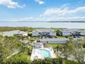 Aerial view of condo complex with pool and parking, overlooking the water at 1125 Edgewater Cir # 13 Sec 1, Bradenton, FL 34209