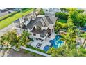Luxury home with private pool, deck, and lush tropical landscaping at 171 Mckinley Dr, Sarasota, FL 34236