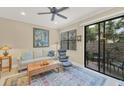 Living room with a comfy sofa, armchairs, and access to a patio at 204 Crew Ct, Sarasota, FL 34243