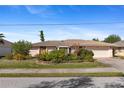 Single-story home with attached garage and manicured landscaping at 339 Rio De Janeiro Ave, Punta Gorda, FL 33983