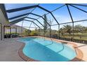 Relaxing kidney-shaped pool with a screened enclosure at 339 Rio De Janeiro Ave, Punta Gorda, FL 33983