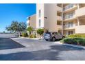 Condo building exterior with parking and landscaping; a car is parked in front at 4110 Ironwood Cir # 301, Bradenton, FL 34209
