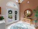 Bright entry with tiled floors, double doors, and a decorative mirror at 4472 Via Del Villetti Dr, Venice, FL 34293
