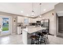 Modern kitchen featuring an island, stainless steel appliances, and granite countertops at 5371 Fleming St, Port Charlotte, FL 33981