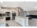 Open concept kitchen with island and stainless steel appliances at 5371 Fleming St, Port Charlotte, FL 33981