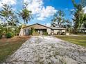 House exterior showcasing a ranch-style home with a gravel driveway at 5645 Churchill Downs Rd, Sarasota, FL 34241