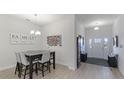 Charming dining area with a farmhouse table and entryway view at 6138 162Nd E Ave, Parrish, FL 34219