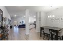 Open concept dining area with a kitchen view and stylish gray chairs at 6138 162Nd E Ave, Parrish, FL 34219