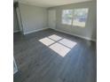 Spacious living room featuring grey vinyl plank flooring and lots of natural light at 739 52Nd N Ave, St Petersburg, FL 33703