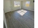 Spacious living room featuring grey vinyl plank flooring and lots of natural light at 739 52Nd N Ave, St Petersburg, FL 33703