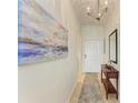 Bright condo entry with wood console table and art at 8105 Grand Estuary Trl # 403, Bradenton, FL 34212