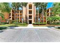 Condo building entrance with landscaping and parking at 8105 Grand Estuary Trl # 403, Bradenton, FL 34212