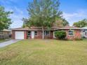 Red brick ranch home with a large grassy yard at 102 N Mars Ave, Clearwater, FL 33755
