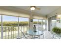 Spacious sunroom with table and chairs and water views at 1109 Edgewater Cir # 1109, Bradenton, FL 34209