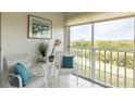 Bright sunroom with seating and serene nature views at 1109 Edgewater Cir # 1109, Bradenton, FL 34209