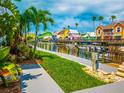 Colorful waterfront homes and palm trees along a canal at 1552 Stickney Point Rd # 403, Sarasota, FL 34231