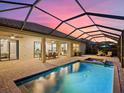 Relaxing screened-in pool and spa area with patio furniture at 16203 Tradewind Ter, Lakewood Ranch, FL 34211