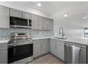 Modern kitchen with stainless steel appliances and quartz countertops at 1751 Beach Rd # 404, Englewood, FL 34223
