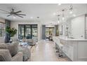 Open concept kitchen with white cabinets, island seating, and stainless steel appliances at 17530 Northwood Pl, Bradenton, FL 34202