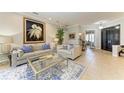 Spacious living room with light colored sofas and a large artwork at 22623 Morning Glory Cir, Bradenton, FL 34202