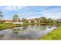 Scenic view of a pond reflecting nearby buildings and a picturesque bridge at 3102 Windrush Bourne # 4, Sarasota, FL 34235
