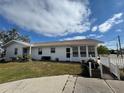 White single-story home with a carport and landscaped yard at 3517 Bahia Vista St, Sarasota, FL 34239