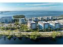 Wide aerial view of waterfront community with lush landscaping at 395 Aruba Cir # 302, Bradenton, FL 34209