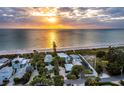 Aerial view of beach house and neighborhood at sunset at 409 Casey Key Rd, Nokomis, FL 34275