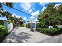 Home with gated entrance and brick driveway at 409 Casey Key Rd, Nokomis, FL 34275