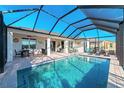 Inviting swimming pool with a covered patio and comfortable seating at 4111 Hemingway Dr, Venice, FL 34293