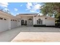 Three-car garage and entrance to a light-colored house at 4214 Palacio Dr, Sarasota, FL 34238
