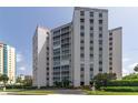 Beautiful condo building with lush landscaping and circular driveway at 435 S Gulfstream Ave # 604, Sarasota, FL 34236