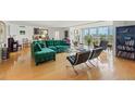 Bright living room featuring a large green couch and expansive city views at 435 S Gulfstream Ave # 604, Sarasota, FL 34236
