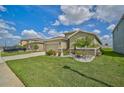 House exterior showcasing a two-car garage and well-maintained lawn at 5282 Grove Mill Loop, Bradenton, FL 34211